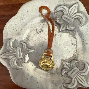 Dooney & Bourke brass  hang tag